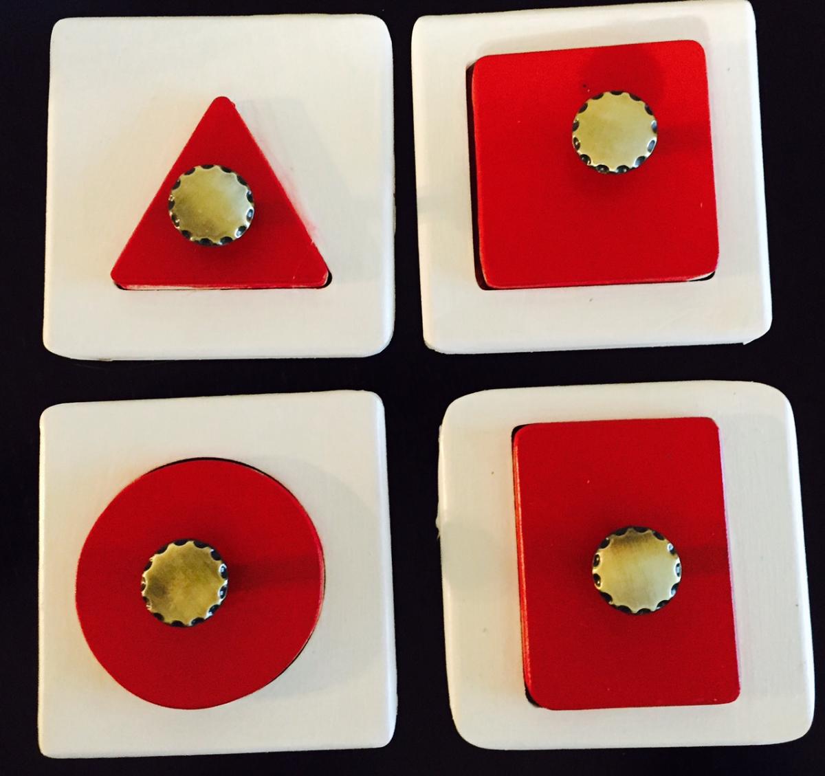 Four different shaped puzzles with knobs