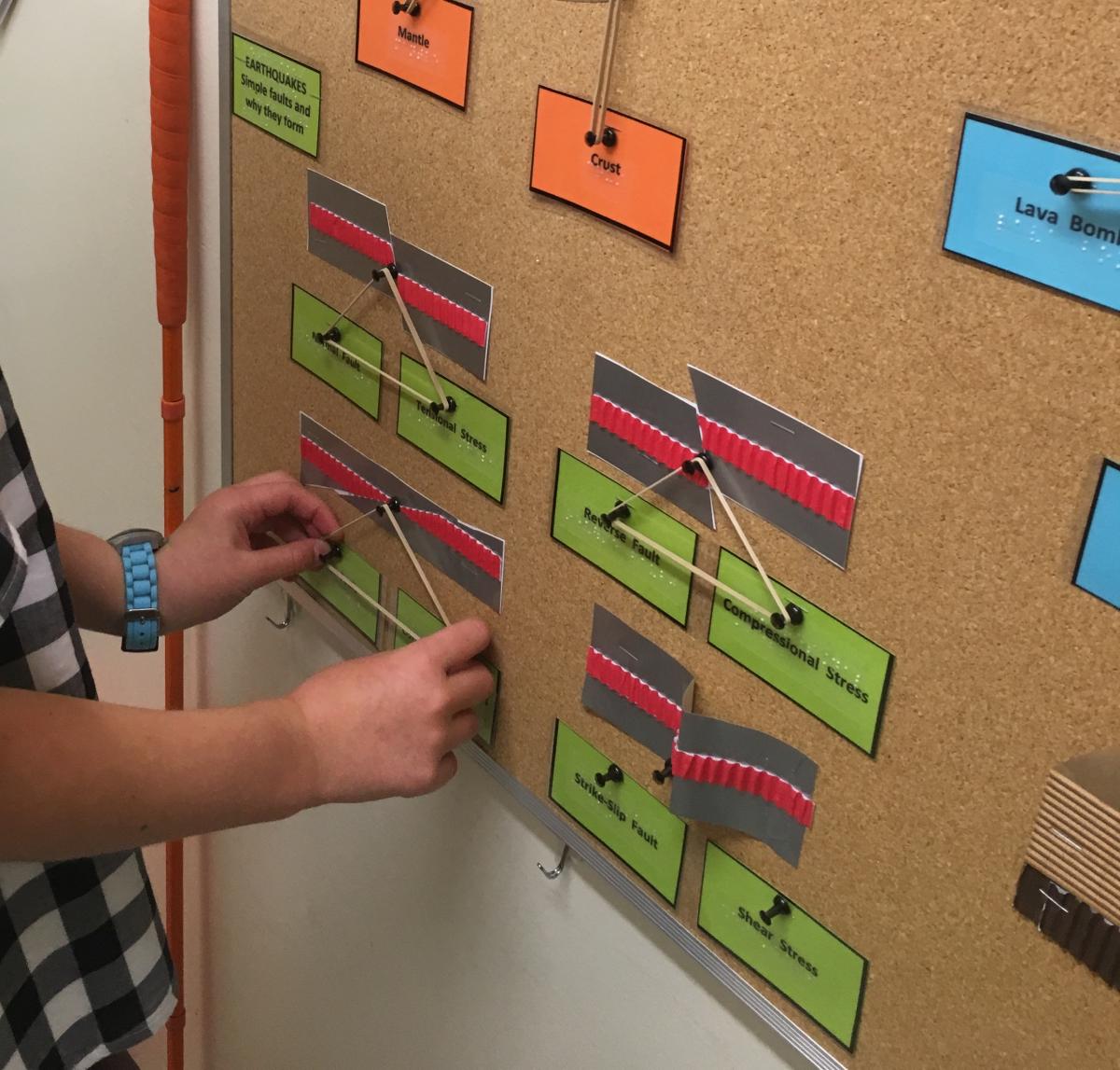 Student exploring interactive earthquake bulletin board