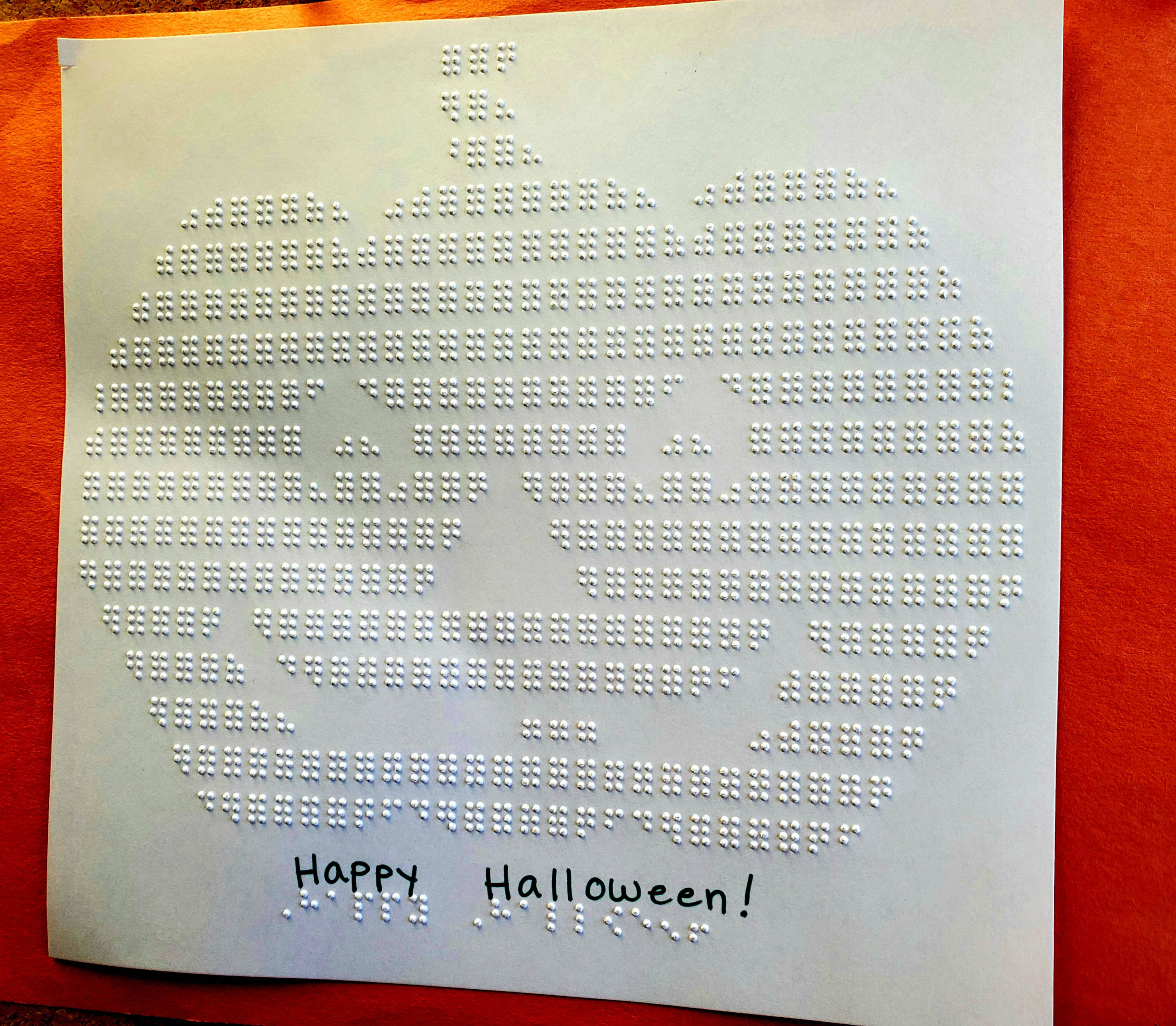 An embossed pumpkin made out of braille