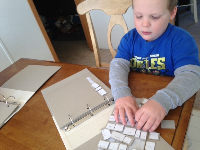 A boy examines braille word cards