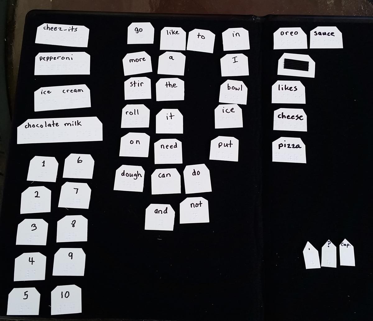 All of the student’s braille word tiles are on a black felt board from APH.