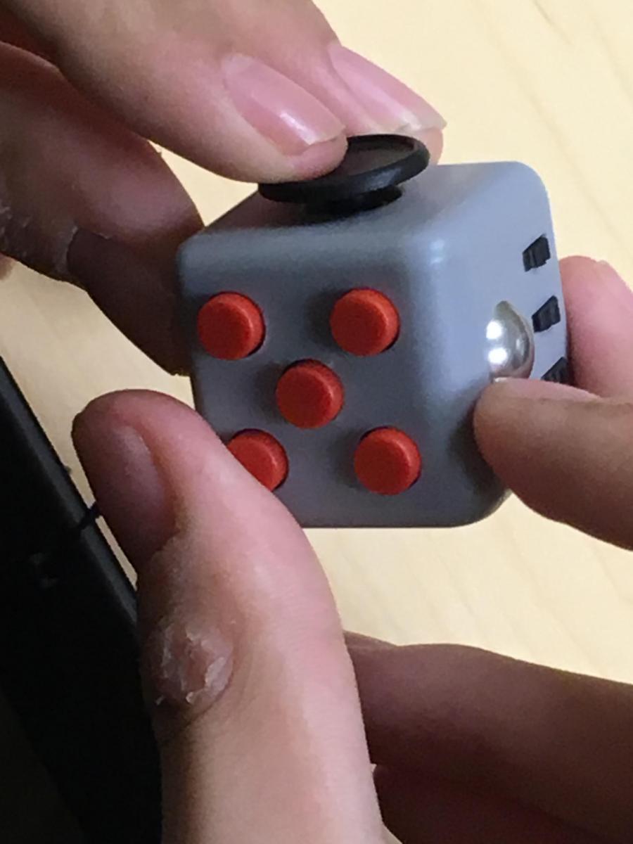 Student with sore thumb using fidget cube