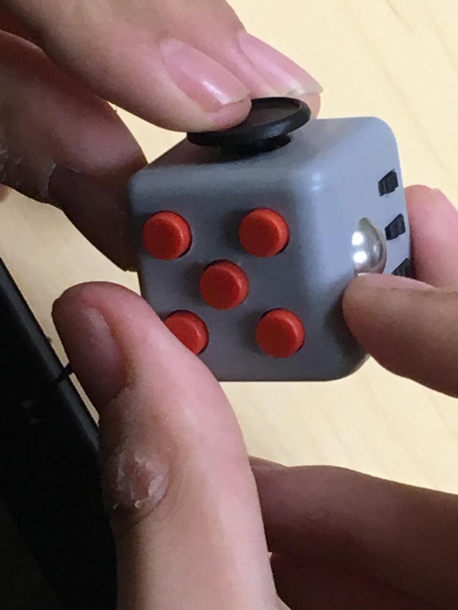 Note skin breakdown where student has been picking at his thumb. Student with sore thumb using fidget cube