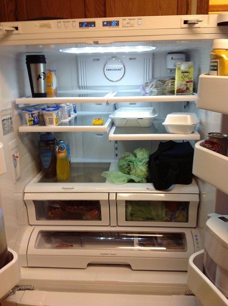 Fridge with the door open and food on the shelves