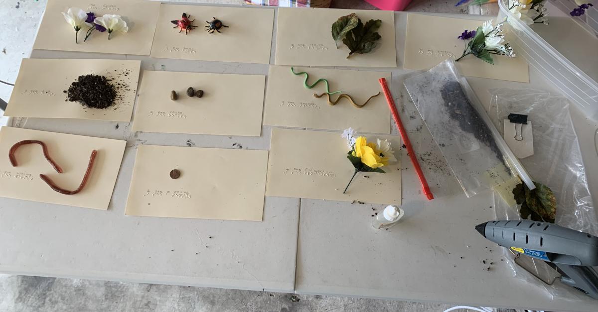 All of the page of the braille story book are laid out on a table.