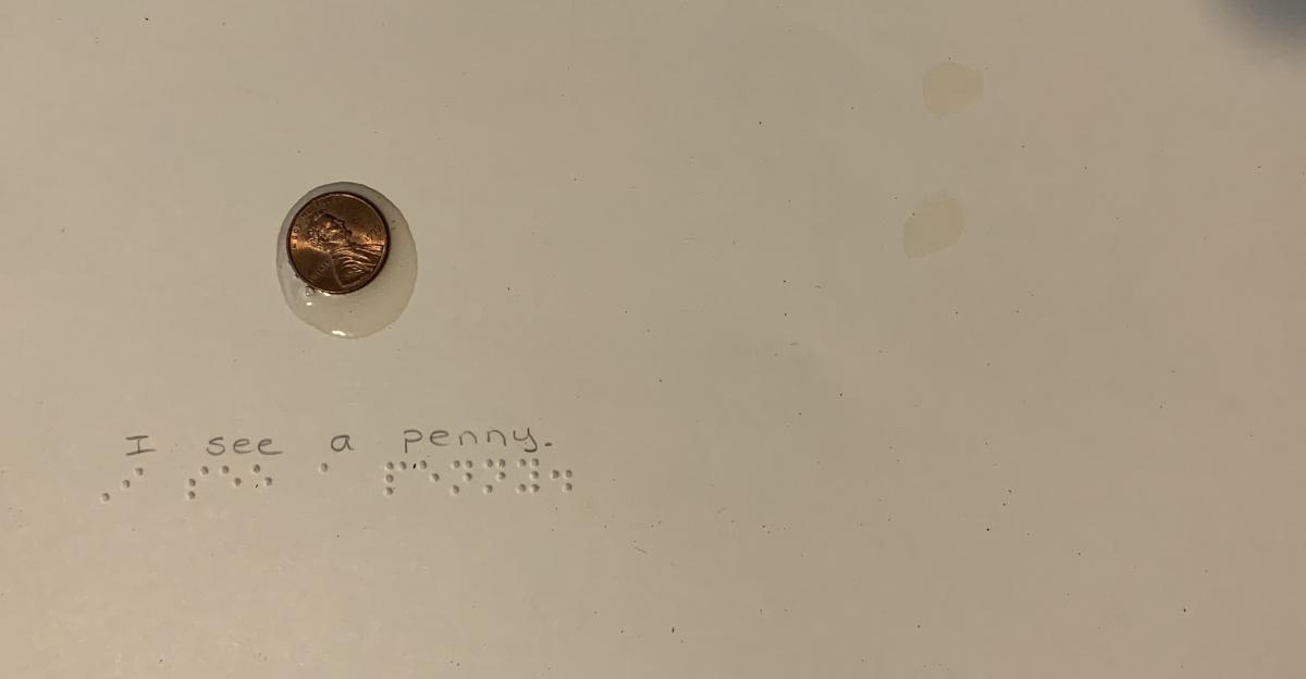 Penny with braille text 