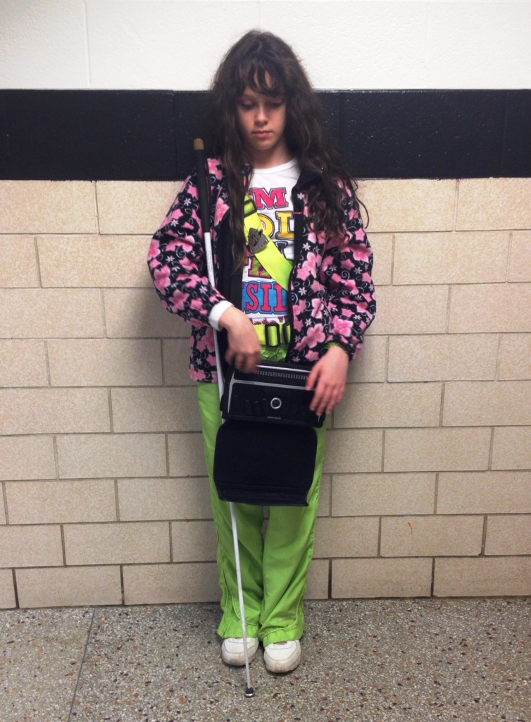 Girl with electronic note-taker in hallway