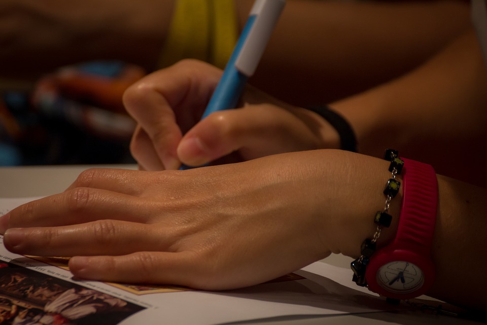 hands writing on paper