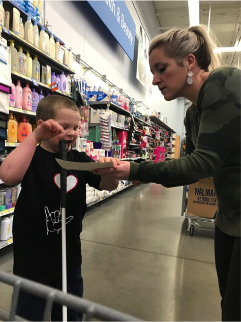 Boy reading braille shopping list