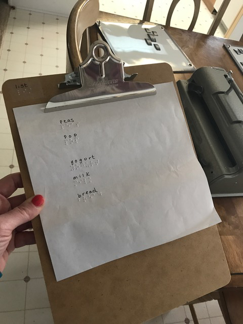 brailled grocery list on clipboard