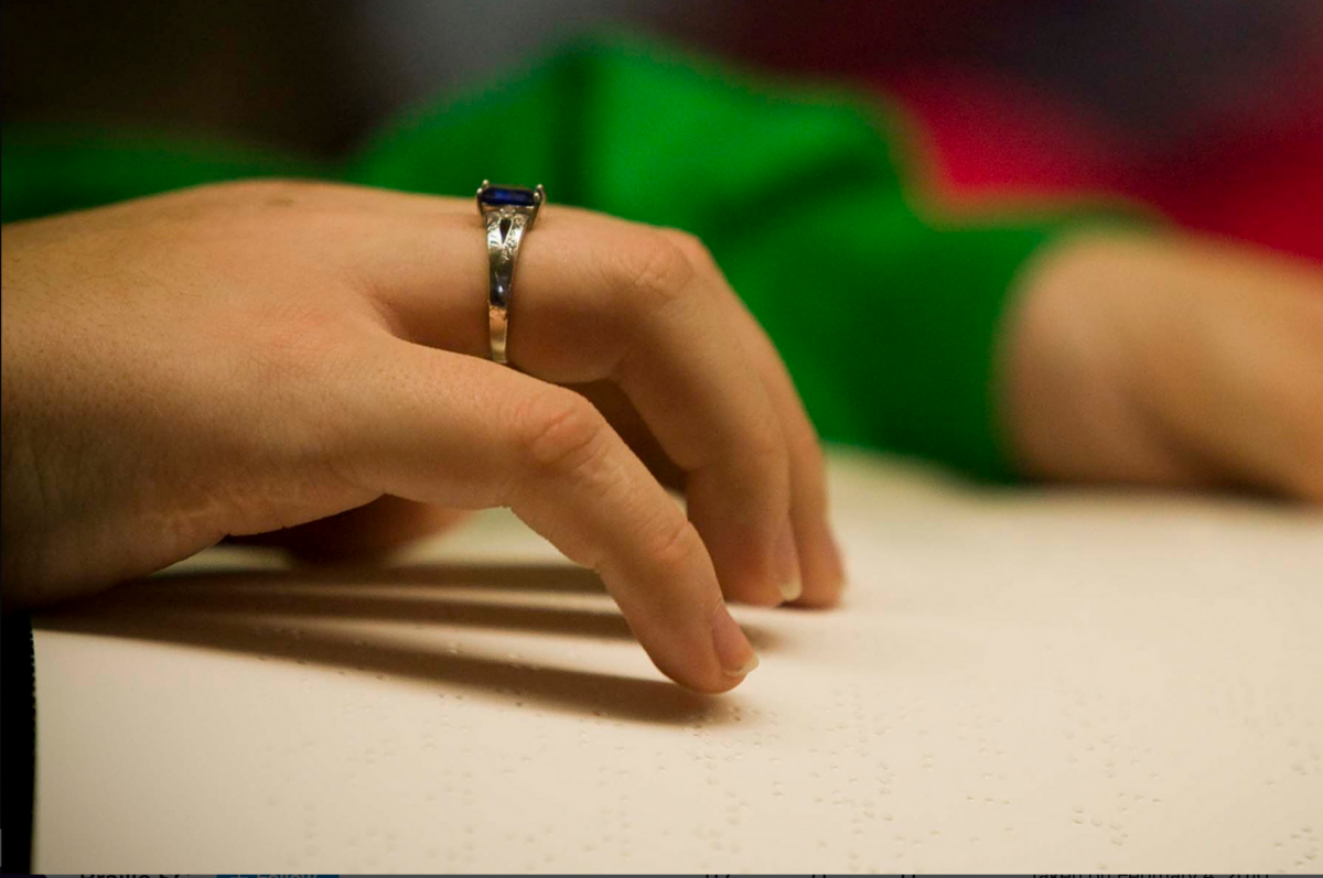 Hand reading braille