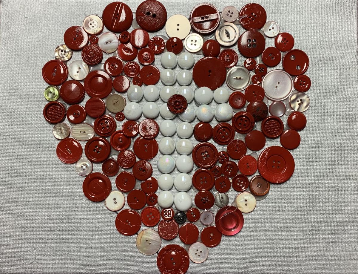 Heart design made of buttons with white cross in center