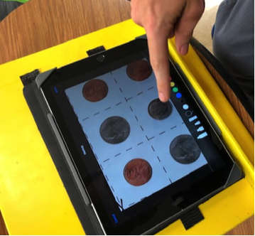 Student selecting coin on iPad