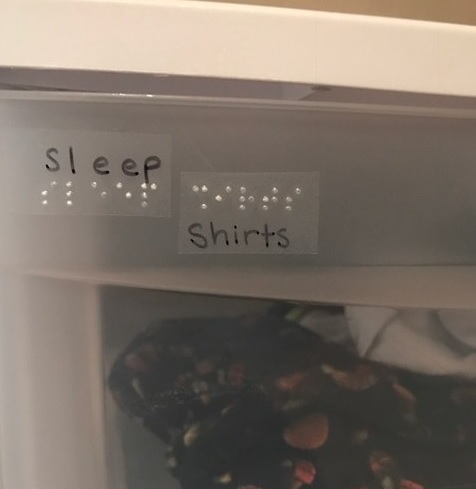 a clothing storage drawer labeled sleep shirts in print and braille