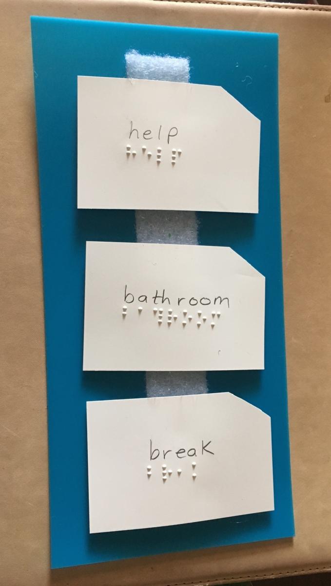 Index cards with help, bathroom, break in print and braille