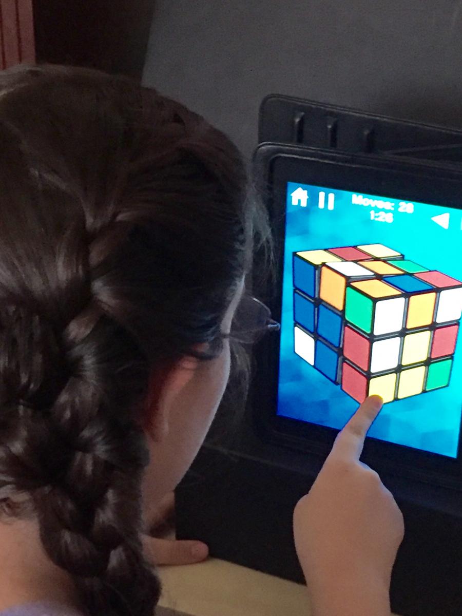 Girl playing game on iPad