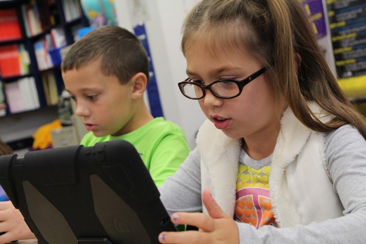 two students looking at iPads 