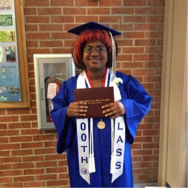 Jasmyn at FSDB graduation with her diploma and gown