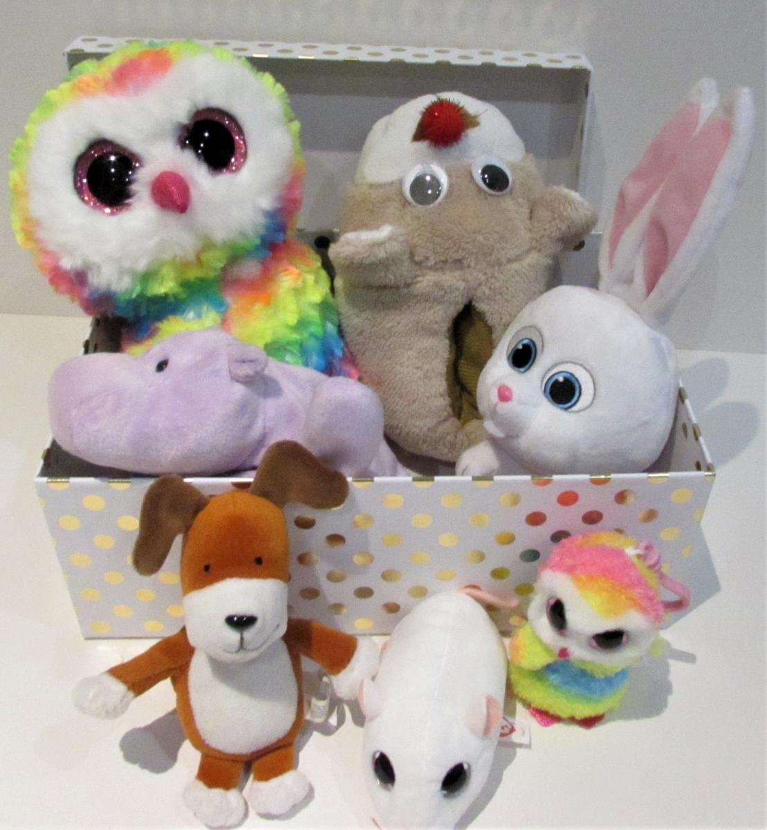 many stuffed toys squeezed into a toy box