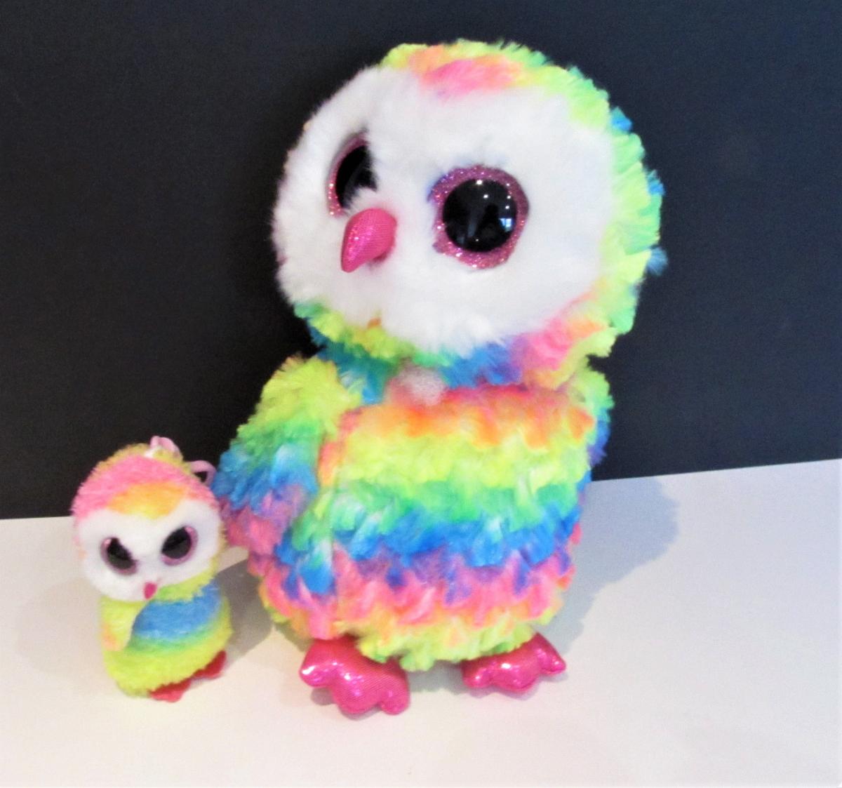a small stuffed owl toy next to a larger stuffed owl toy