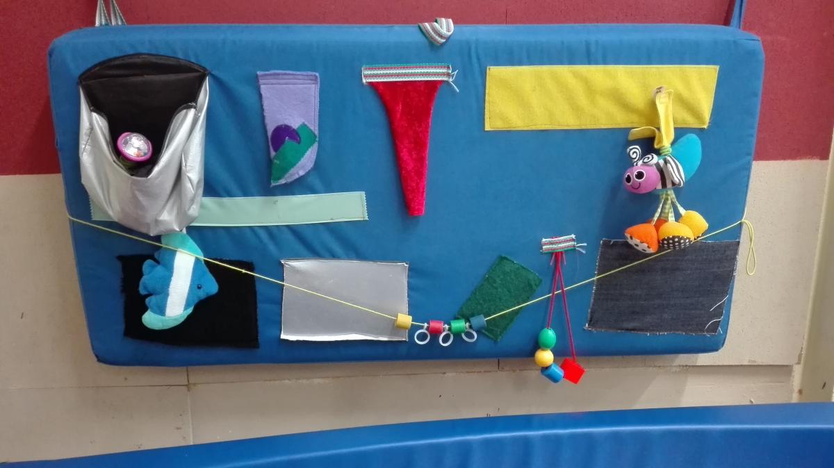 an exploration board with many tactile and sensory objects