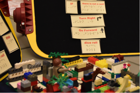 A student-created Lego maze is shown with coding instructions in tactile print and braille. A student created Lego maze is shown with coding instructions in tactile print and Braille.