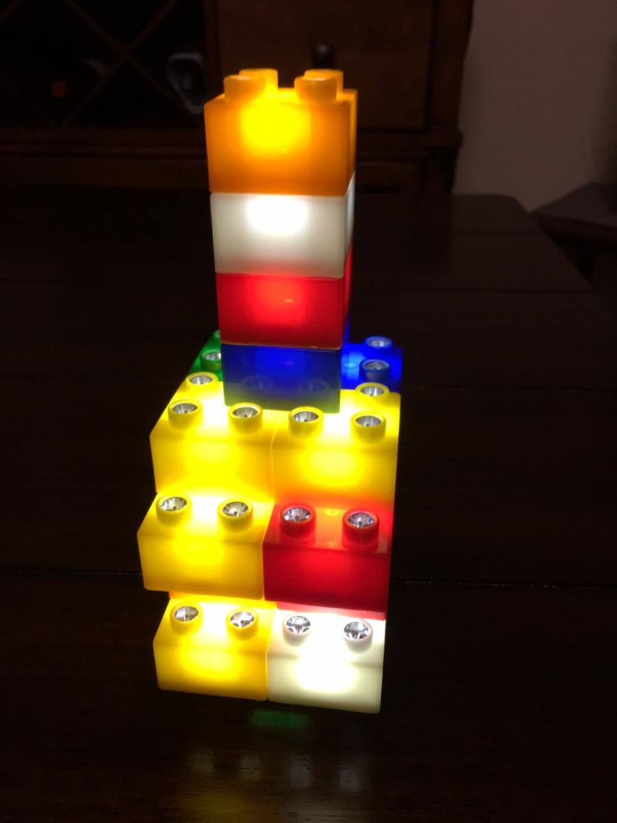 different lego blocks with lights inside of them built into a tower