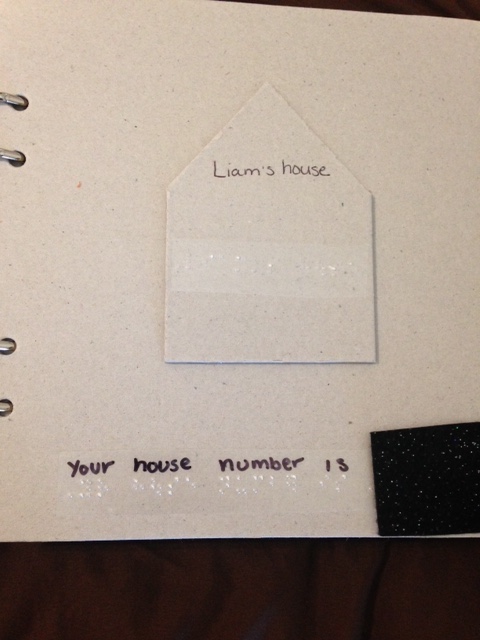 Tactile symbol of house with braille label