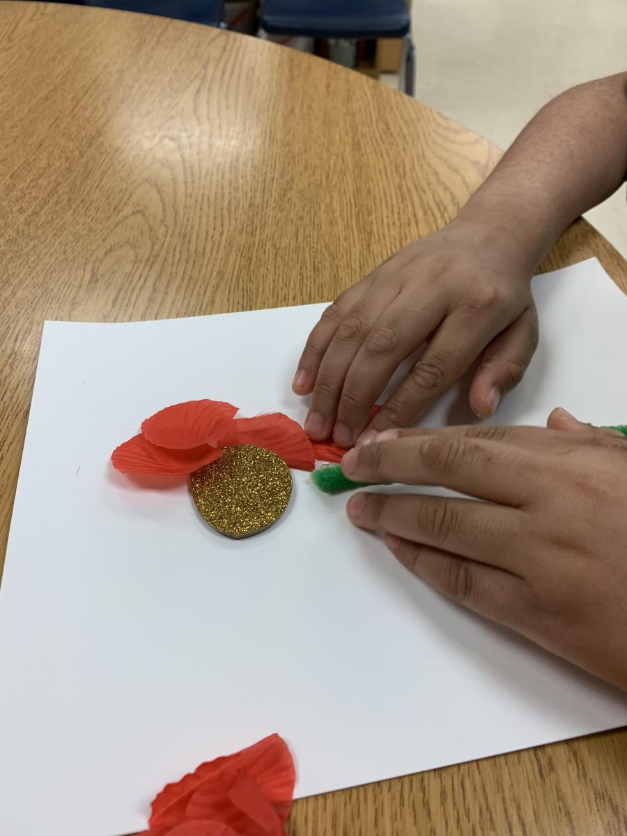 Arranging the parts of the flower on the paper