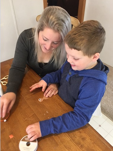 Liam and his mother putting together the construction paper turkeys