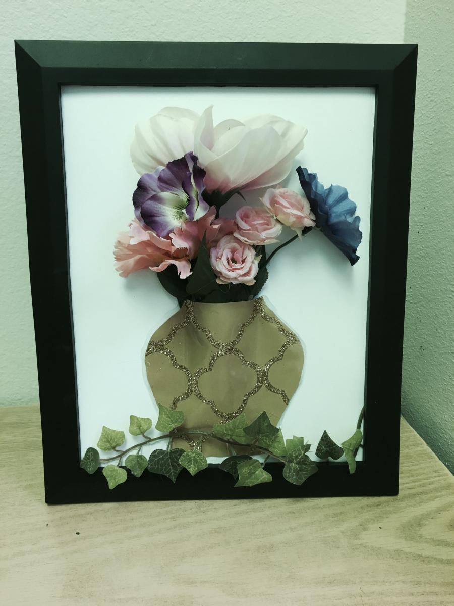 framed picture of a flower vase showing the texture of the paper vase cut from a gift bag
