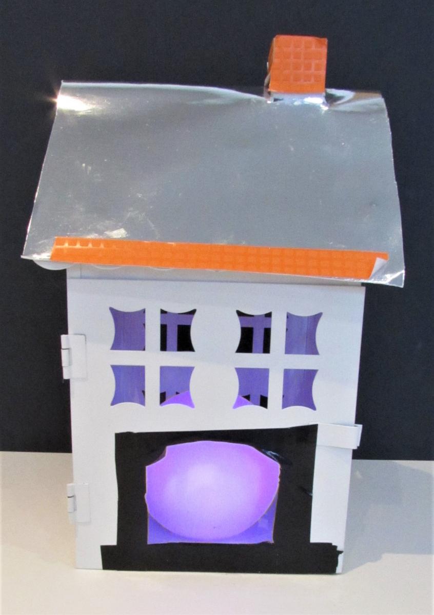 cardboard house with aluminum foil roof, cut out windows and door