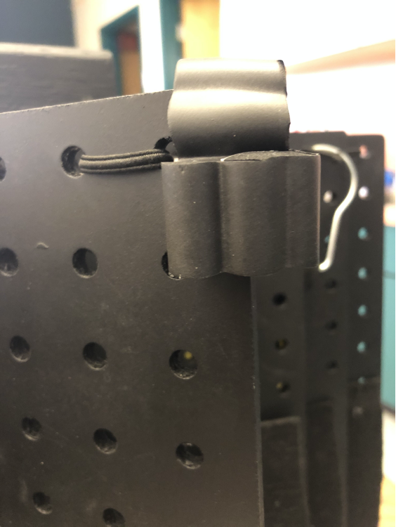 Corners of pegboard book covered with black foam Corners of pegboard book covered with black foam
