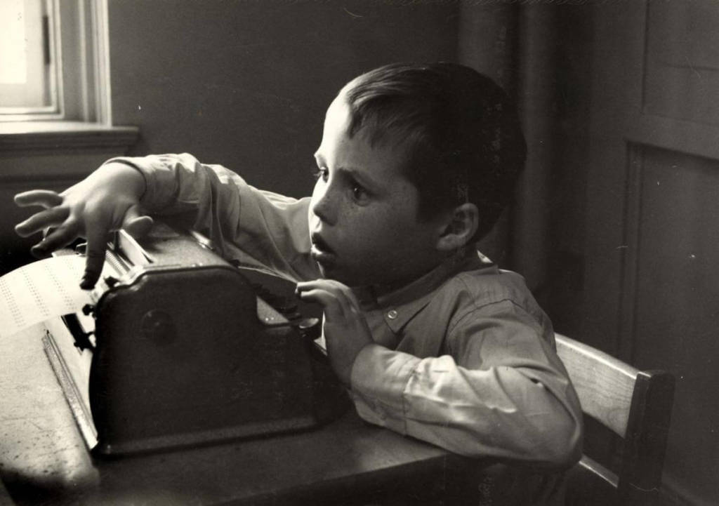 young boy reads braille 