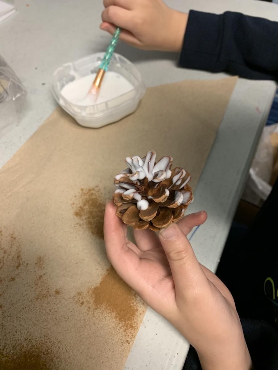 Painting the pinecone with glue