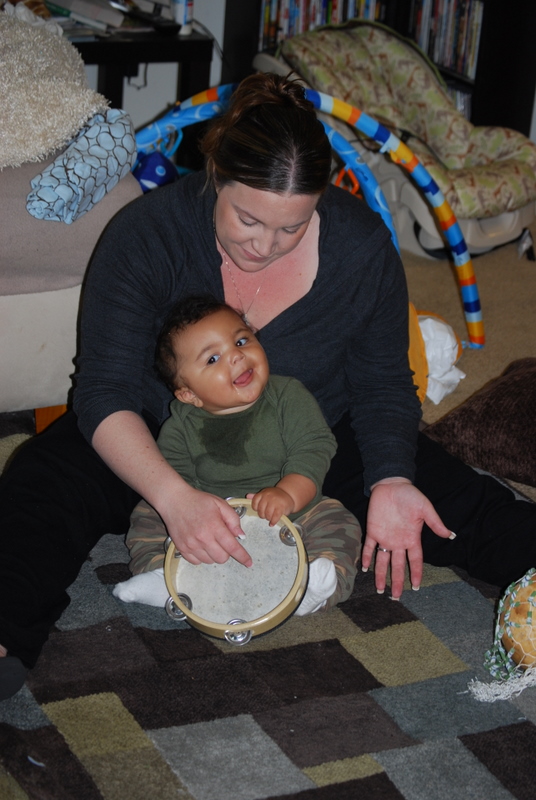 Young child playing tambourine