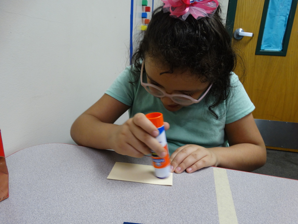 Click to view Student using glue stick