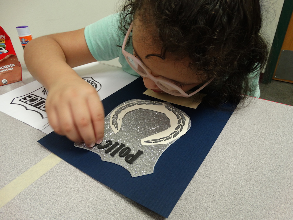 Click to view student putting together police letter