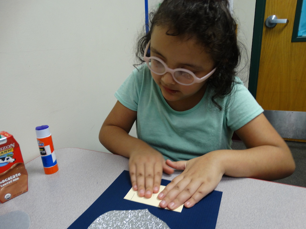 Click to view student glueing something to the police letter