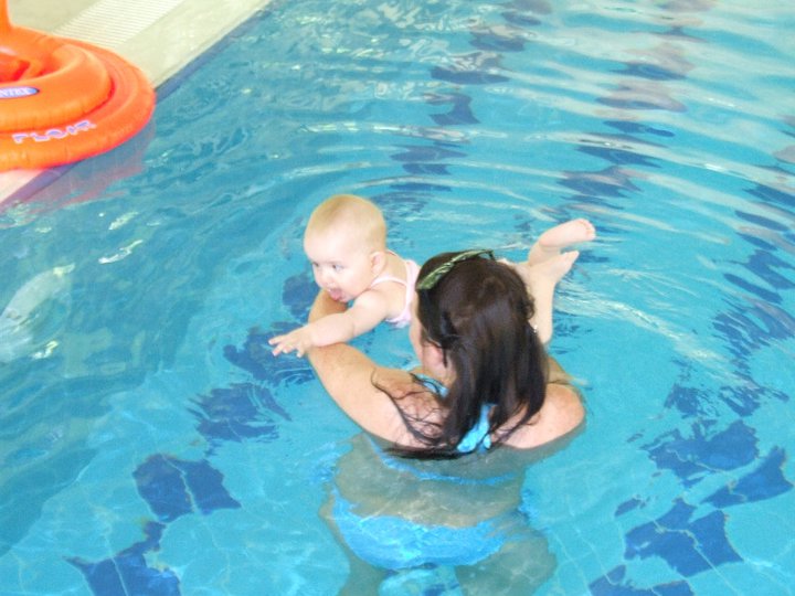 woman with baby in pool