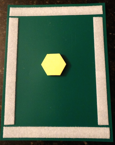 green board with velcro and a yellow hexagon