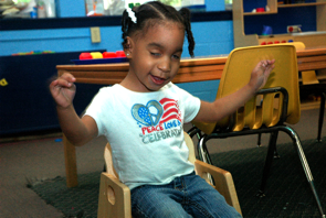 Preschool student with arms spread wide