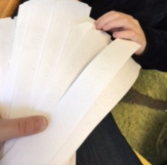 Braille student selecting a writing prompt student selecting a writing prompt from a bunch of options
