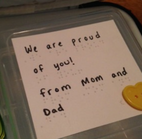 lunch box with braille and text