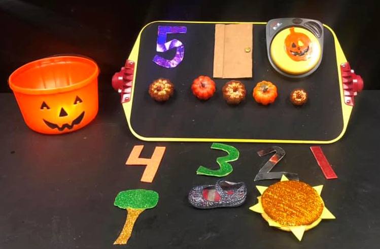Five Little Pumpkins items for students that include 5 plastic pumkins on a felt board and a larger pumpkin with a flashlight, with tactile numbers