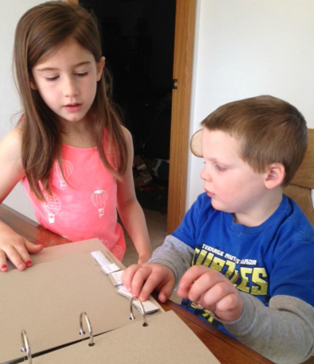 Two children read book together