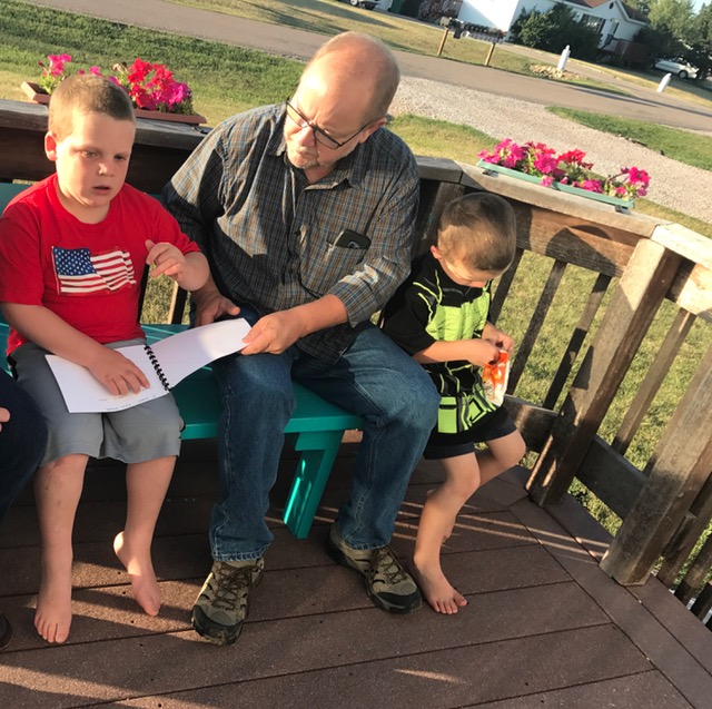 Reading the book to grandfather