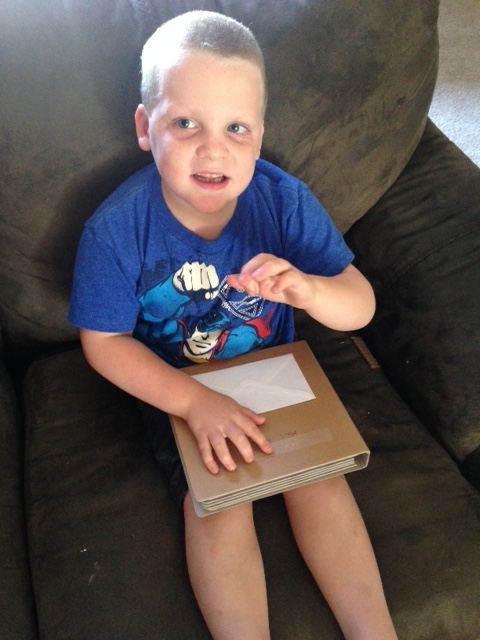 Young boy reading mail book