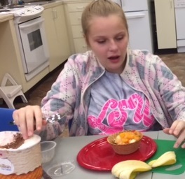 A girl registers her surprise at the dessert she created.