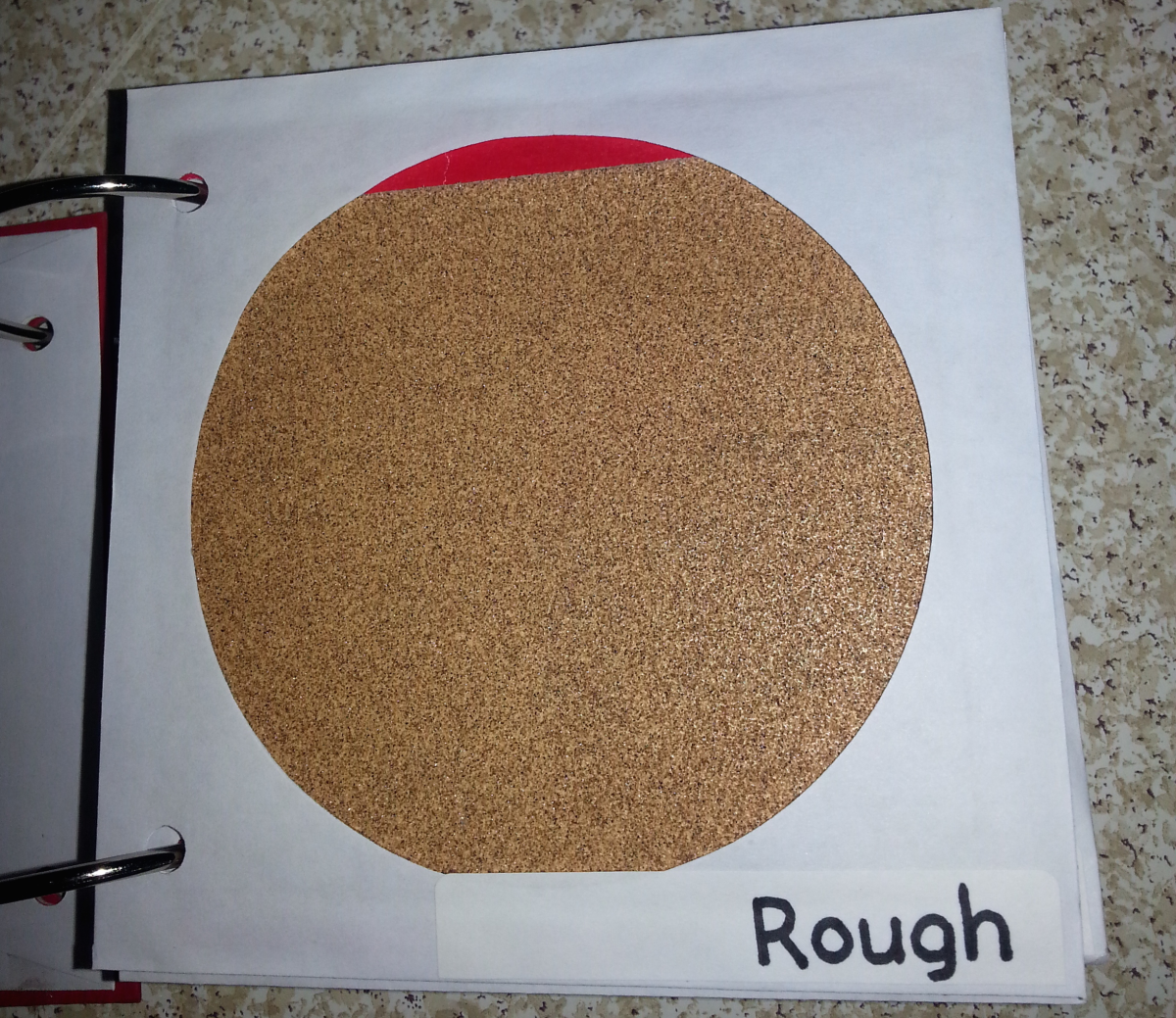 rough texture page with red circle with sandpaper